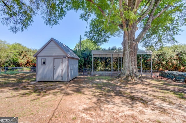 view of shed with a fenced backyard and a carport