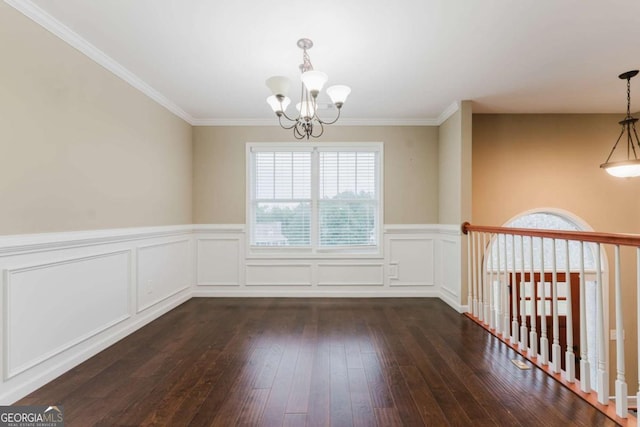 204 Arapahoe Ct, Villa Rica, GA 30180 - unfurnished dining area with a wainscoted wall, a notable chandelier, ornamental molding, and dark wood-style flooring