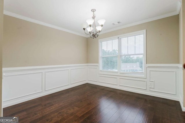 204 Arapahoe Ct, Villa Rica, GA 30180 - unfurnished dining area featuring dark wood-type flooring, wainscoting, ornamental molding, and an inviting chandelier