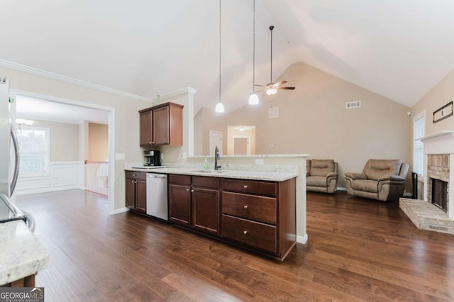 204 Arapahoe Ct, Villa Rica, GA 30180 - kitchen featuring stainless steel appliances, a sink, open floor plan, a ceiling fan, and a brick fireplace