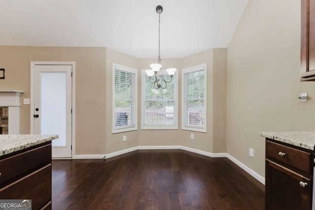 204 Arapahoe Ct, Villa Rica, GA 30180 - unfurnished dining area featuring baseboards, dark wood-style flooring, and an inviting chandelier