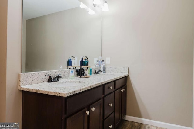 204 Arapahoe Ct, Villa Rica, GA 30180 - full bathroom with baseboards, wood finished floors, a sink, and double vanity