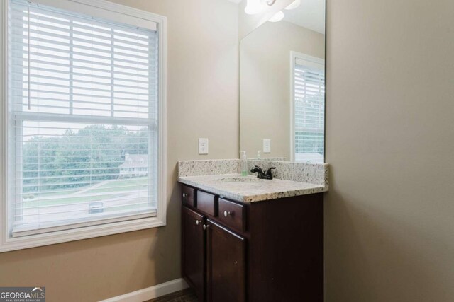 204 Arapahoe Ct, Villa Rica, GA 30180 - bathroom featuring a healthy amount of sunlight, vanity, and baseboards