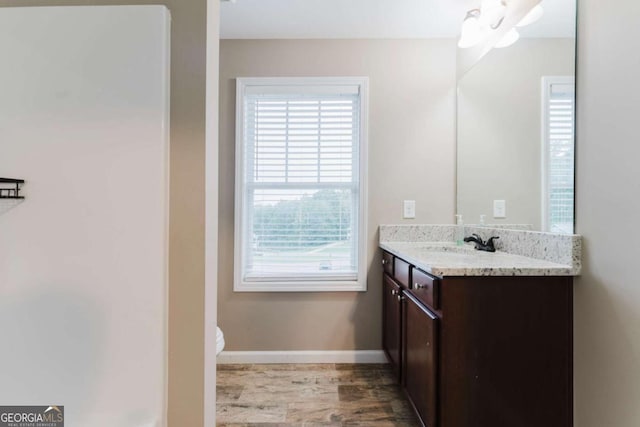 204 Arapahoe Ct, Villa Rica, GA 30180 - bathroom featuring baseboards, toilet, vanity, and wood finished floors