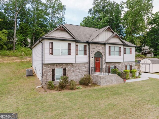 204 Arapahoe Ct, Villa Rica, GA 30180 - bi-level home featuring a front lawn, a shed, board and batten siding, an outbuilding, and brick siding