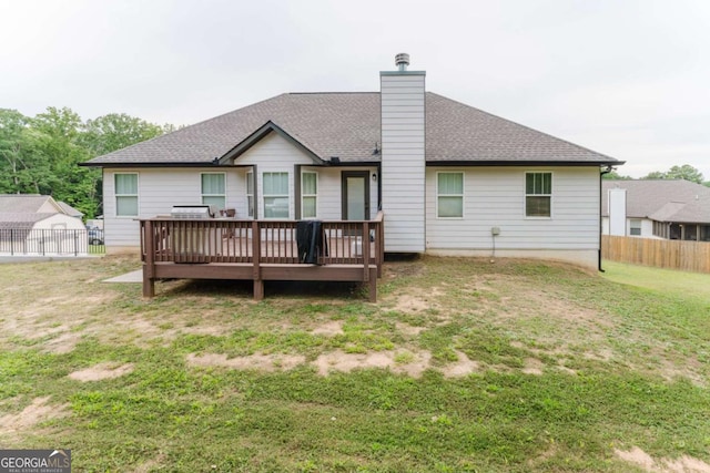 204 Arapahoe Ct, Villa Rica, GA 30180 - rear view of property with a chimney, fence, a yard, roof with shingles, and a deck