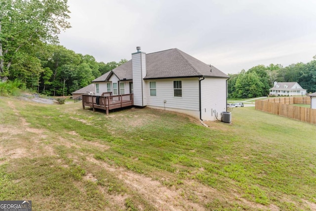 204 Arapahoe Ct, Villa Rica, GA 30180 - back of property featuring central AC unit, a chimney, a deck, fence, and a yard