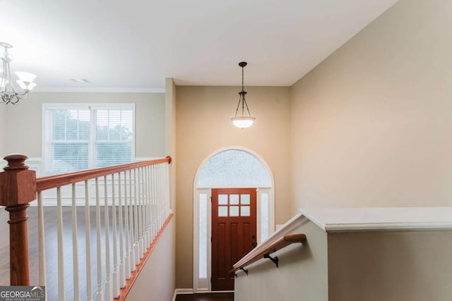 204 Arapahoe Ct, Villa Rica, GA 30180 - entrance foyer featuring baseboards, ornamental molding, wood finished floors, and a chandelier