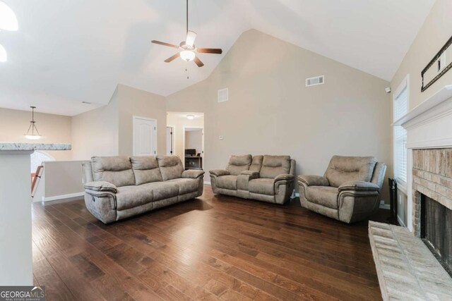 204 Arapahoe Ct, Villa Rica, GA 30180 - living room featuring hardwood / wood-style floors, visible vents, a ceiling fan, a brick fireplace, and high vaulted ceiling