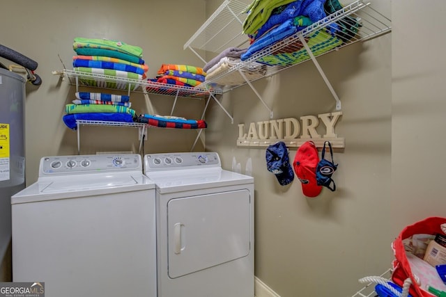 2 Blue Heron Dr, Monticello, GA 31064 - clothes washing area featuring washer and clothes dryer, water heater, laundry area, and baseboards