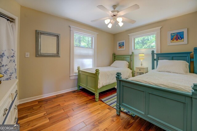 2 Blue Heron Dr, Monticello, GA 31064 - bedroom with light wood-style floors, multiple windows, baseboards, and ceiling fan
