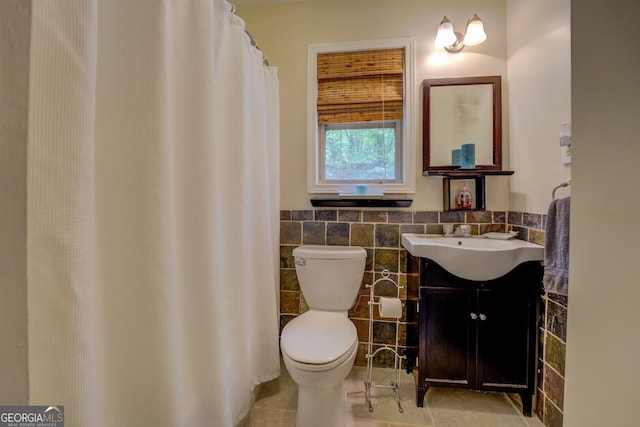 2 Blue Heron Dr, Monticello, GA 31064 - bathroom with vanity, toilet, wainscoting, tile walls, and tile patterned floors