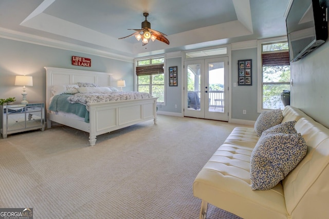 2 Blue Heron Dr, Monticello, GA 31064 - bedroom featuring baseboards, french doors, access to exterior, a tray ceiling, and light colored carpet