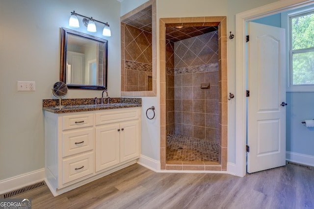 2 Blue Heron Dr, Monticello, GA 31064 - full bathroom featuring visible vents, baseboards, a shower stall, vanity, and wood finished floors