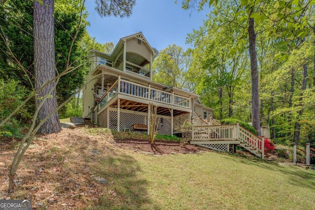 2 Blue Heron Dr, Monticello, GA 31064 - back of property featuring stairway, a wooden deck, and a lawn