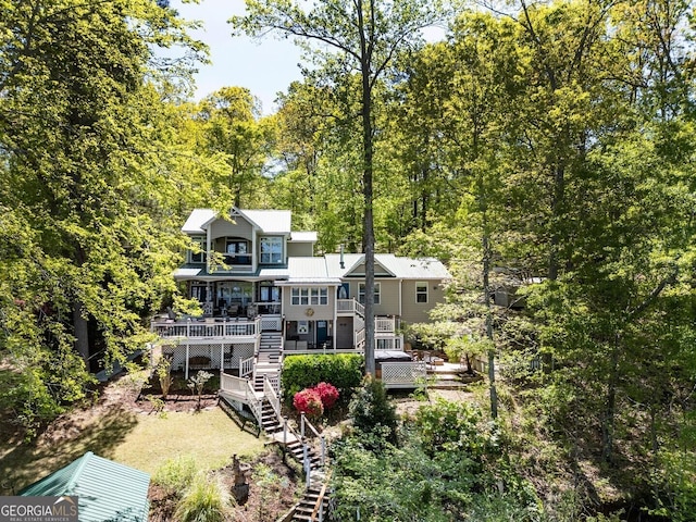 2 Blue Heron Dr, Monticello, GA 31064 - back of property with a view of trees, a deck, and stairs