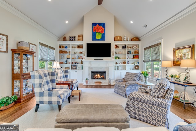 2616 Bent Pine Dr, Statham, GA 30666 - living room featuring crown molding, wood finished floors, a tile fireplace, recessed lighting, and high vaulted ceiling