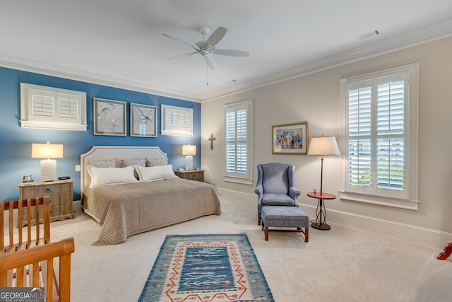 carpeted bedroom featuring ornamental molding, baseboards, a ceiling fan, and visible vents