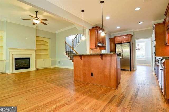 974 Regal Hills Ln, Mableton, GA 30126 - kitchen with baseboards, stainless steel refrigerator with ice dispenser, a breakfast bar, a peninsula, and light wood finished floors