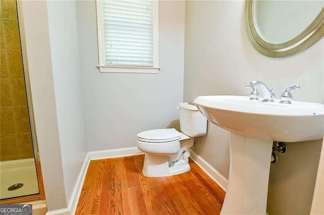 974 Regal Hills Ln, Mableton, GA 30126 - bathroom with a shower stall, baseboards, toilet, and wood finished floors