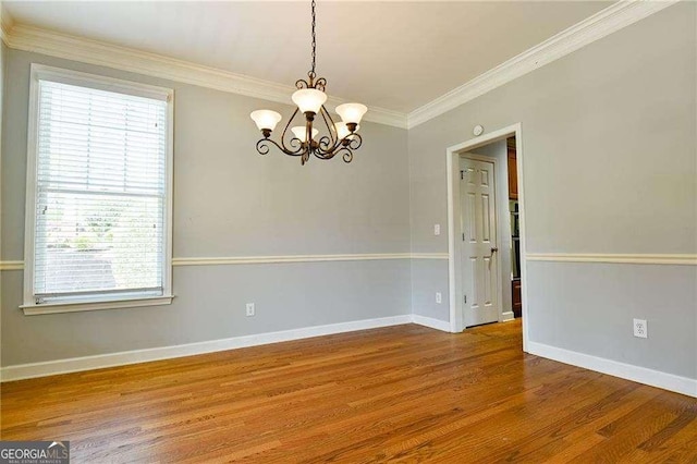 974 Regal Hills Ln, Mableton, GA 30126 - empty room featuring crown molding, baseboards, a chandelier, and wood finished floors