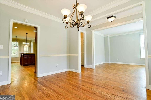 974 Regal Hills Ln, Mableton, GA 30126 - unfurnished dining area with a chandelier, light wood finished floors, baseboards, and ornamental molding