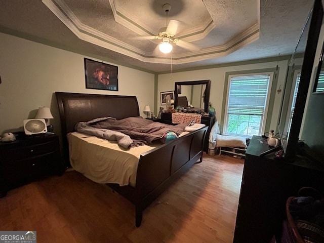 525 Brooksdale Dr, Woodstock, GA 30189 - bedroom with a tray ceiling, crown molding, wood finished floors, and a ceiling fan