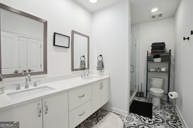 1050 Stacks Ave SE Unit 1507, Atlanta, GA 30315 - full bath featuring toilet, baseboards, a stall shower, double vanity, and tile patterned floors