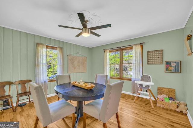 dining room featuring a wealth of natural light, baseboards, and crown molding