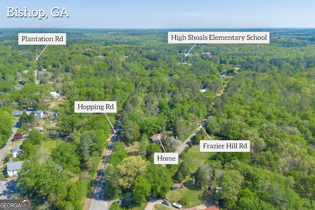 birds eye view of property with a view of trees