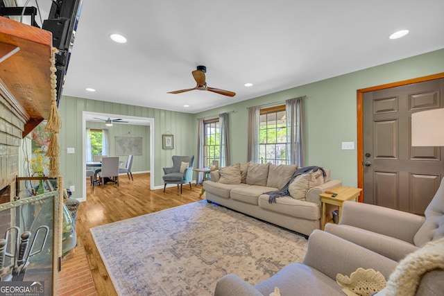 living room featuring wood finished floors, baseboards, a ceiling fan, and recessed lighting
