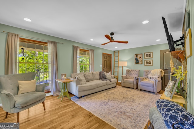 living area featuring wood finished floors, a ceiling fan, and recessed lighting