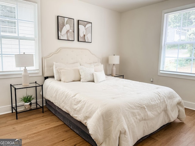 947 Reed Ave, East Point, GA 30344 - bedroom featuring wood finished floors, multiple windows, and baseboards