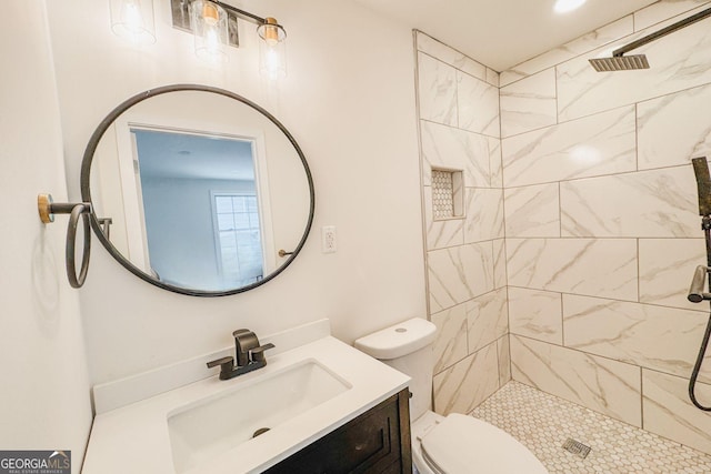 947 Reed Ave, East Point, GA 30344 - bathroom featuring tiled shower, toilet, and vanity