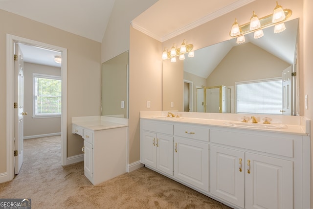 bathroom with a stall shower, double vanity, a sink, and vaulted ceiling