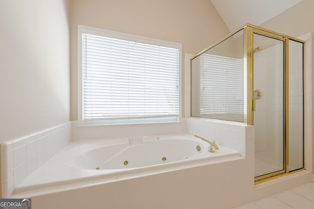 bathroom featuring a stall shower and a tub with jets