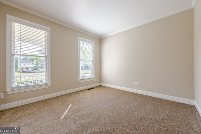 unfurnished room with baseboards, ornamental molding, visible vents, and carpet floors