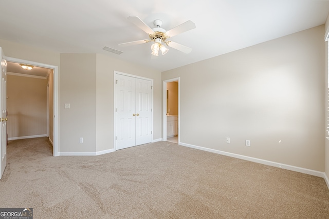 unfurnished bedroom featuring a closet, baseboards, and light colored carpet