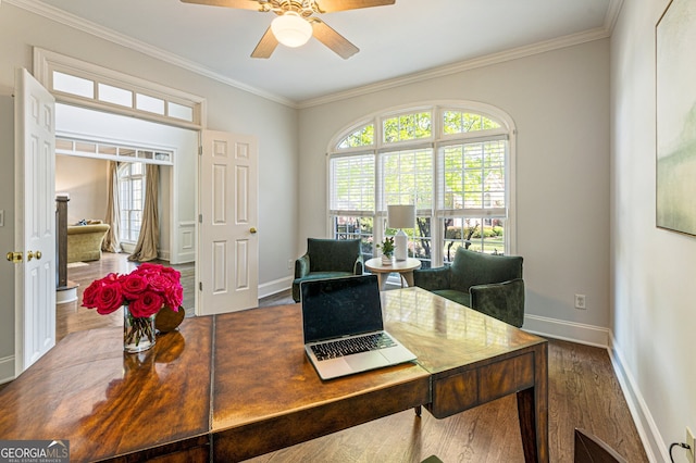 home office with crown molding, wood finished floors, ceiling fan, and plenty of natural light