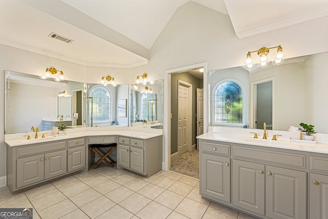 bathroom with tile patterned floors, visible vents, a sink, and lofted ceiling