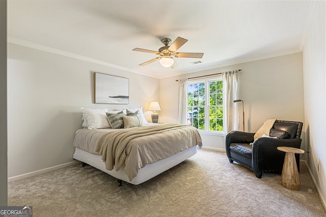 carpeted bedroom featuring baseboards, crown molding, and ceiling fan