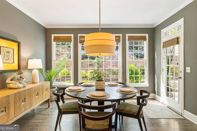 dining space with crown molding, baseboards, and dark wood-style floors