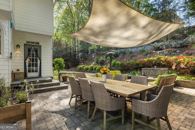 view of patio with entry steps and outdoor dining area