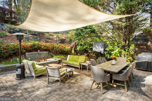 view of patio / terrace with area for grilling, outdoor dining area, and an outdoor living space with a fire pit