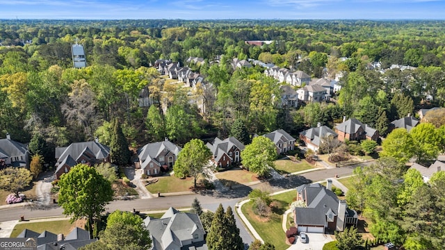 birds eye view of property with a wooded view and a residential view