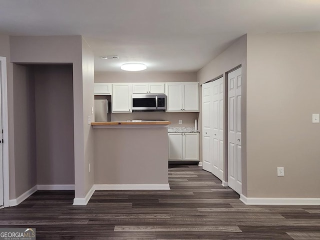 6401 Wedgeview Ct Unit 6401, Tucker, GA 30084 - kitchen featuring appliances with stainless steel finishes, baseboards, dark wood finished floors, and white cabinets