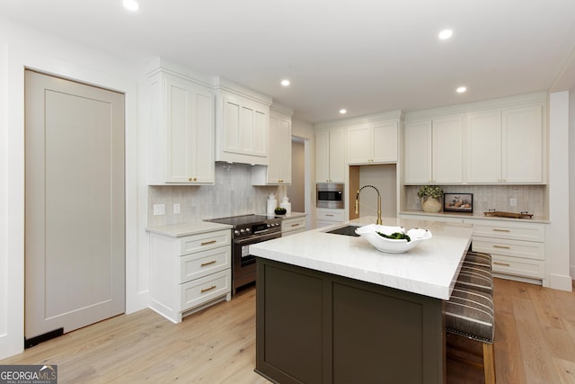 5535 Chestatee Landing Way, Gainesville, GA 30506 - kitchen featuring stainless steel electric range oven, a sink, white cabinetry, backsplash, and recessed lighting