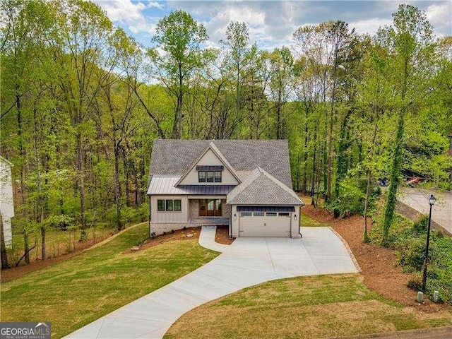 5535 Chestatee Landing Way, Gainesville, GA 30506 - view of front of property with driveway, a front lawn, a garage, a forest view, and metal roof