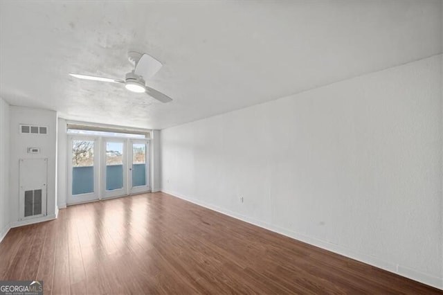 unfurnished living room with wood finished floors, baseboards, a ceiling fan, and visible vents