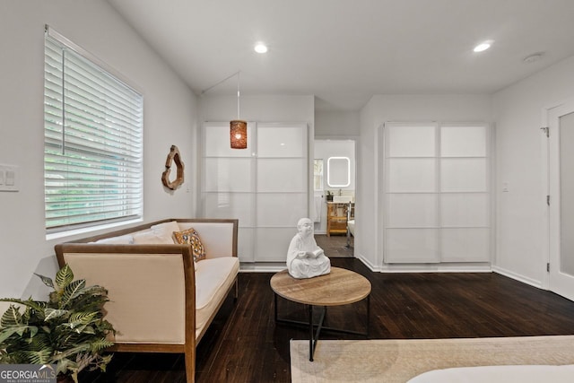 sitting room with dark wood-style floors and recessed lighting
